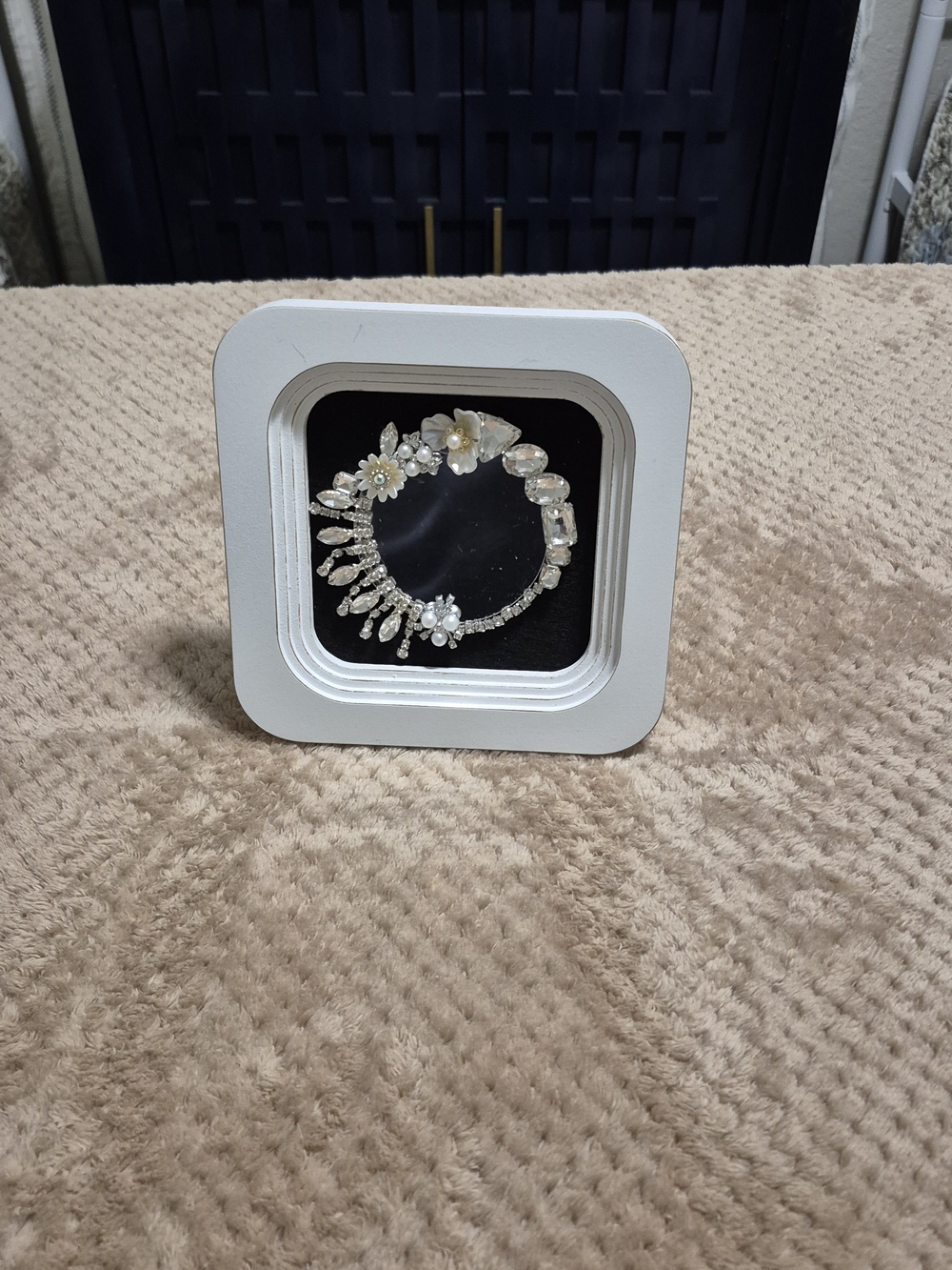 White Floating Display Frame with Decorative Silver Bracelet